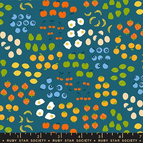 Patterned fabric with fruits, vegetables, and eggs on a blue background, featuring the Ruby Star Society label.