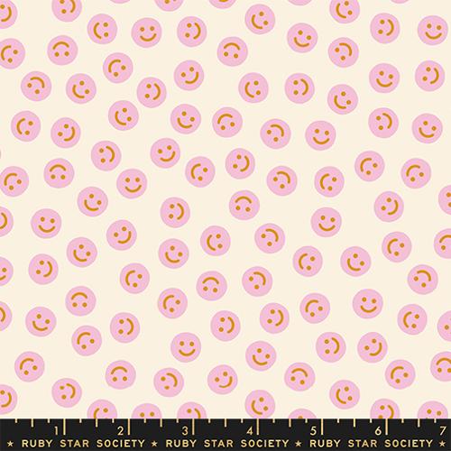 Pattern of pink smiley faces on a beige background with Ruby Star Society label.