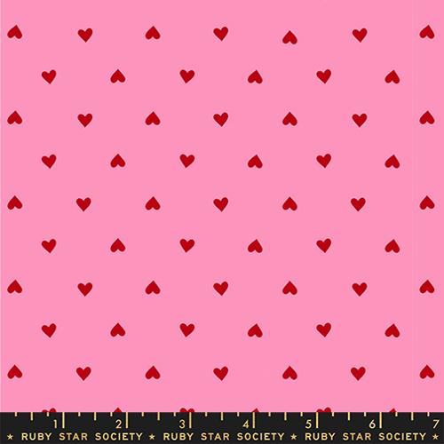 Pink fabric with red heart pattern and Ruby Star Society label at the bottom.