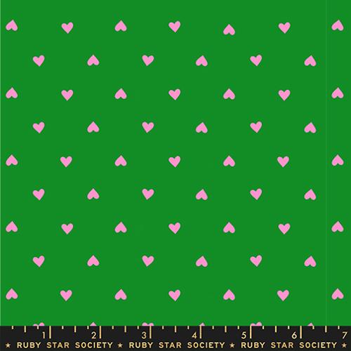 Pattern of pink hearts on a green background with Ruby Star Society label.