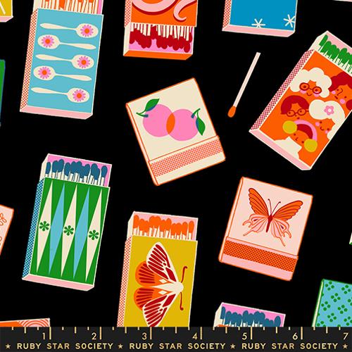 Colorful matchboxes with various designs on a black background, featuring the Ruby Star Society label.