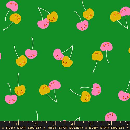 Pattern of colorful cherries with smiling faces on a green background, featuring Ruby Star Society label.