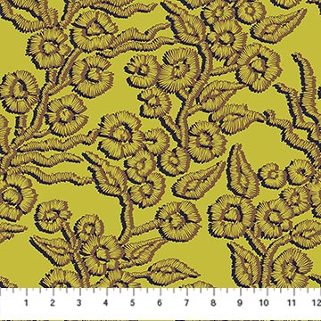 Embroidered floral pattern on a yellow fabric with a ruler at the bottom.