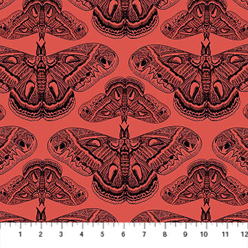 Red fabric with moth pattern and a ruler at the bottom