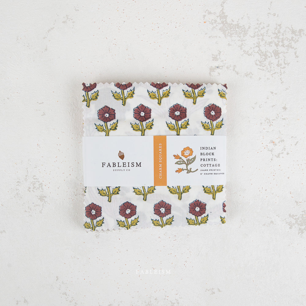 Pack of Fableism products with floral design on a textured white background