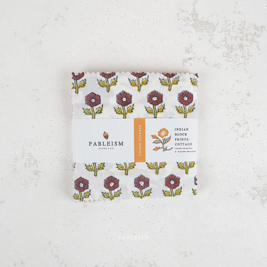 Pack of Fableism products with floral design on a textured white background
