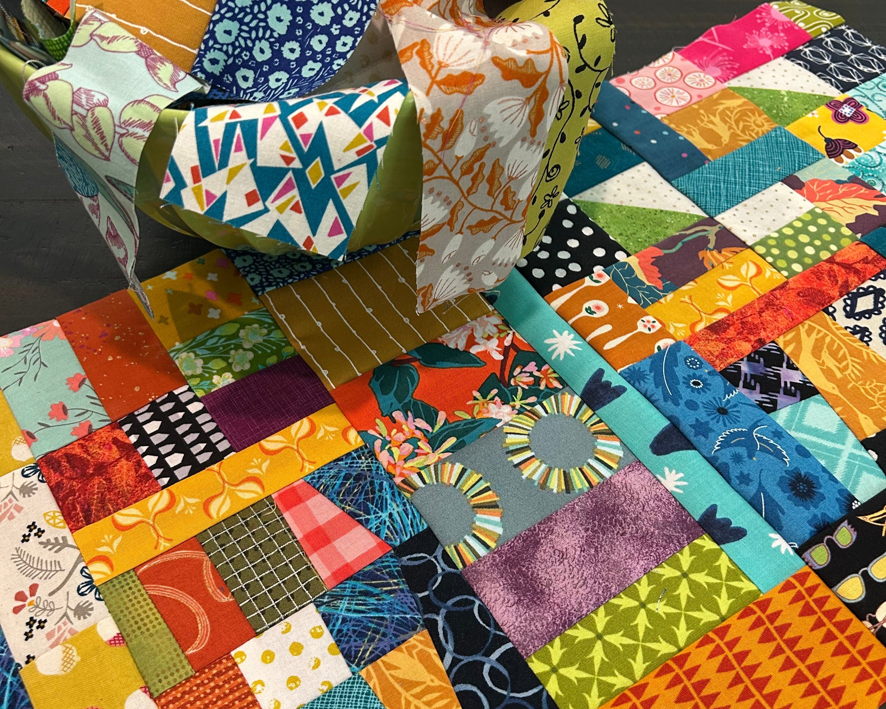 Colorful patchwork quilt with various patterns and colors.