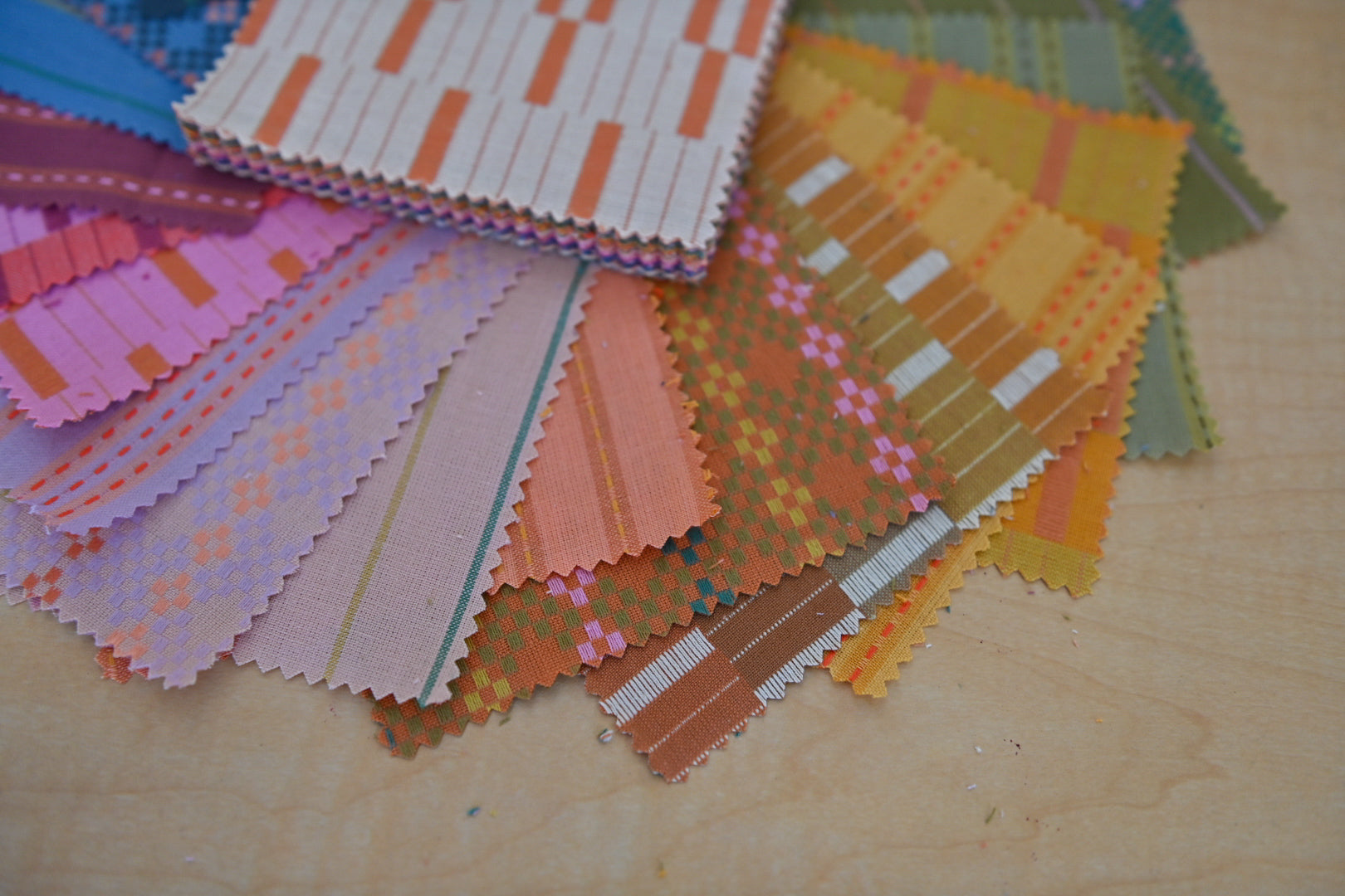 Color swatches with various patterns on a wooden surface