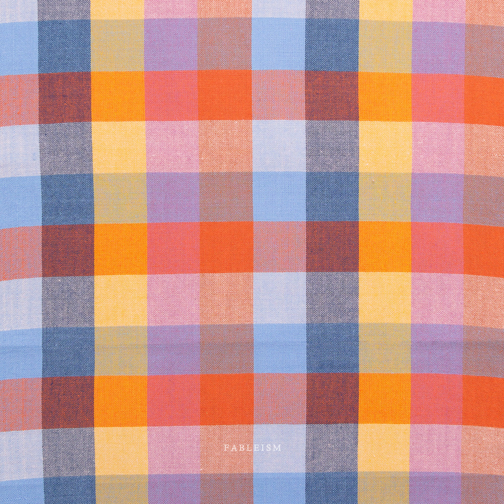 Multicolored checkered fabric pattern with visible brand name 'Fabletics'.