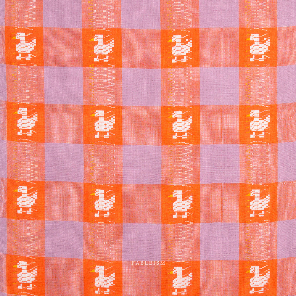 Checkered pattern with duck illustrations in orange and purple squares