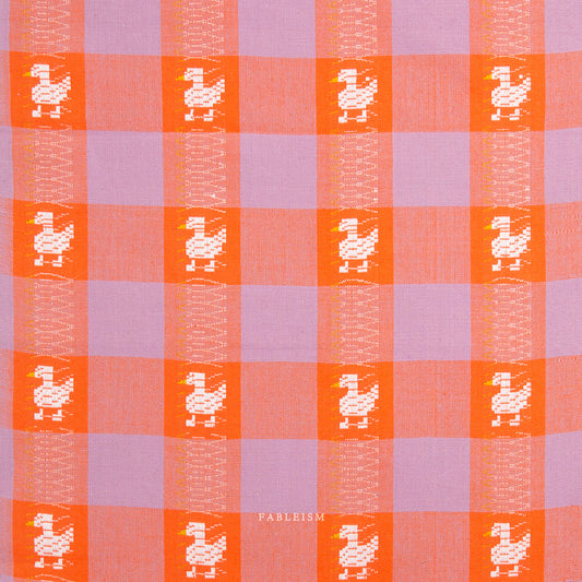 Checkered pattern with duck illustrations in orange and purple squares