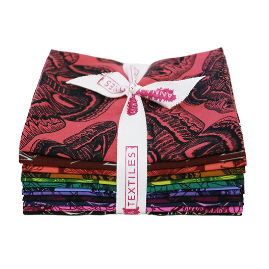 Stack of colorful fabric bundles tied with a white ribbon on a white background