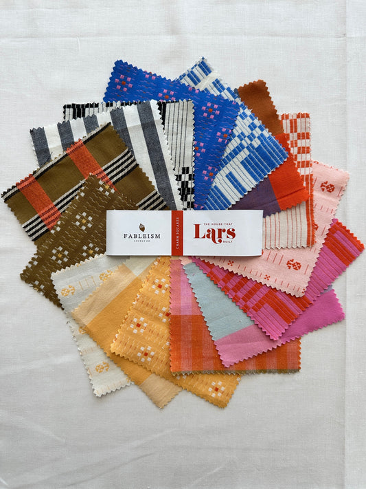 House that Lars Built Charm Squares arranged in a colorful splay 