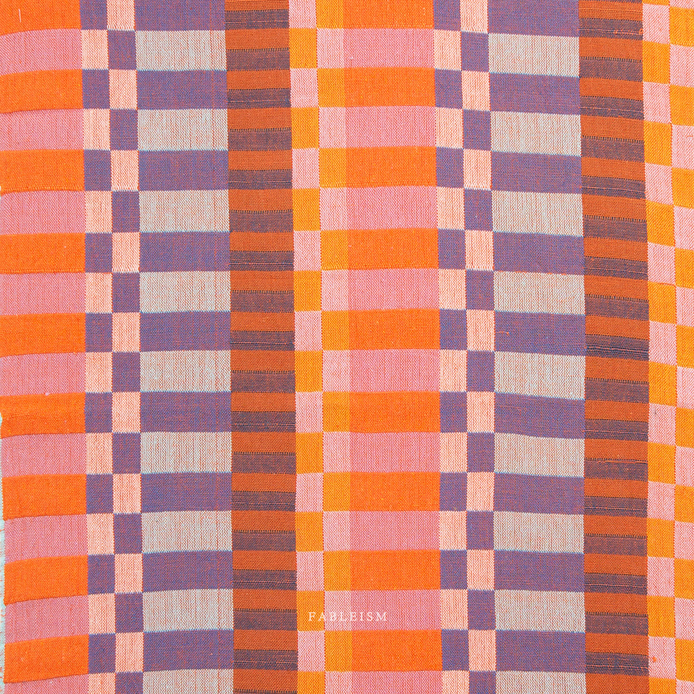 Plaid pattern fabric swatch in orange, purple, and pink.