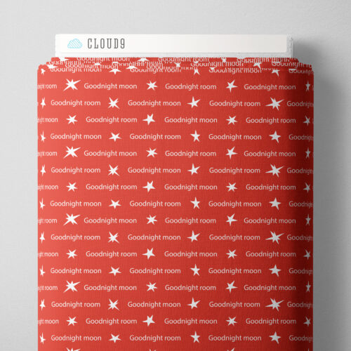 Red blanket with 'Goodnight moon' text and star patterns on a white background