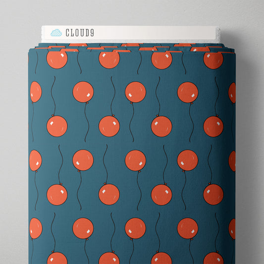 A bolt of fabric with red cartoon ballons against a blue background 