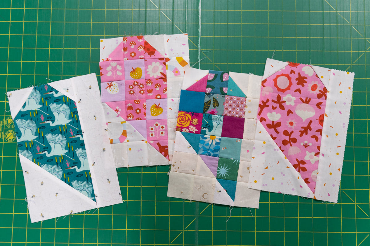 Colorful quilt blocks on a green cutting mat