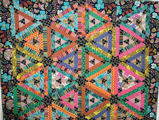 Colorful geometric quilt with triangles on a dark background