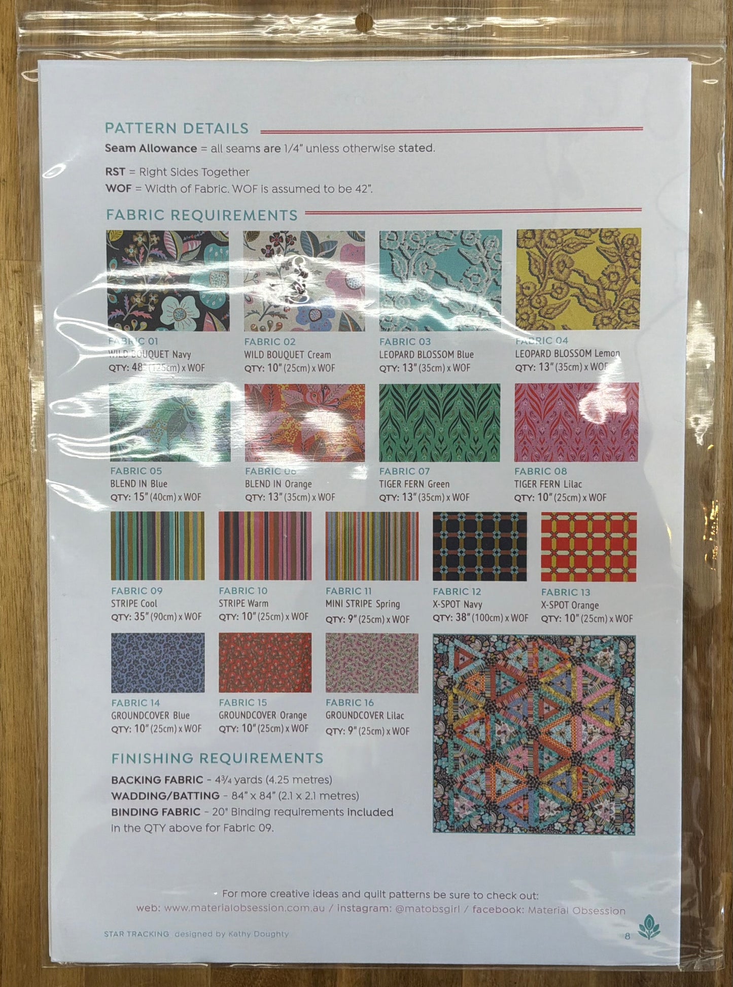 Pattern details sheet with fabric swatches and measurements on a wooden surface