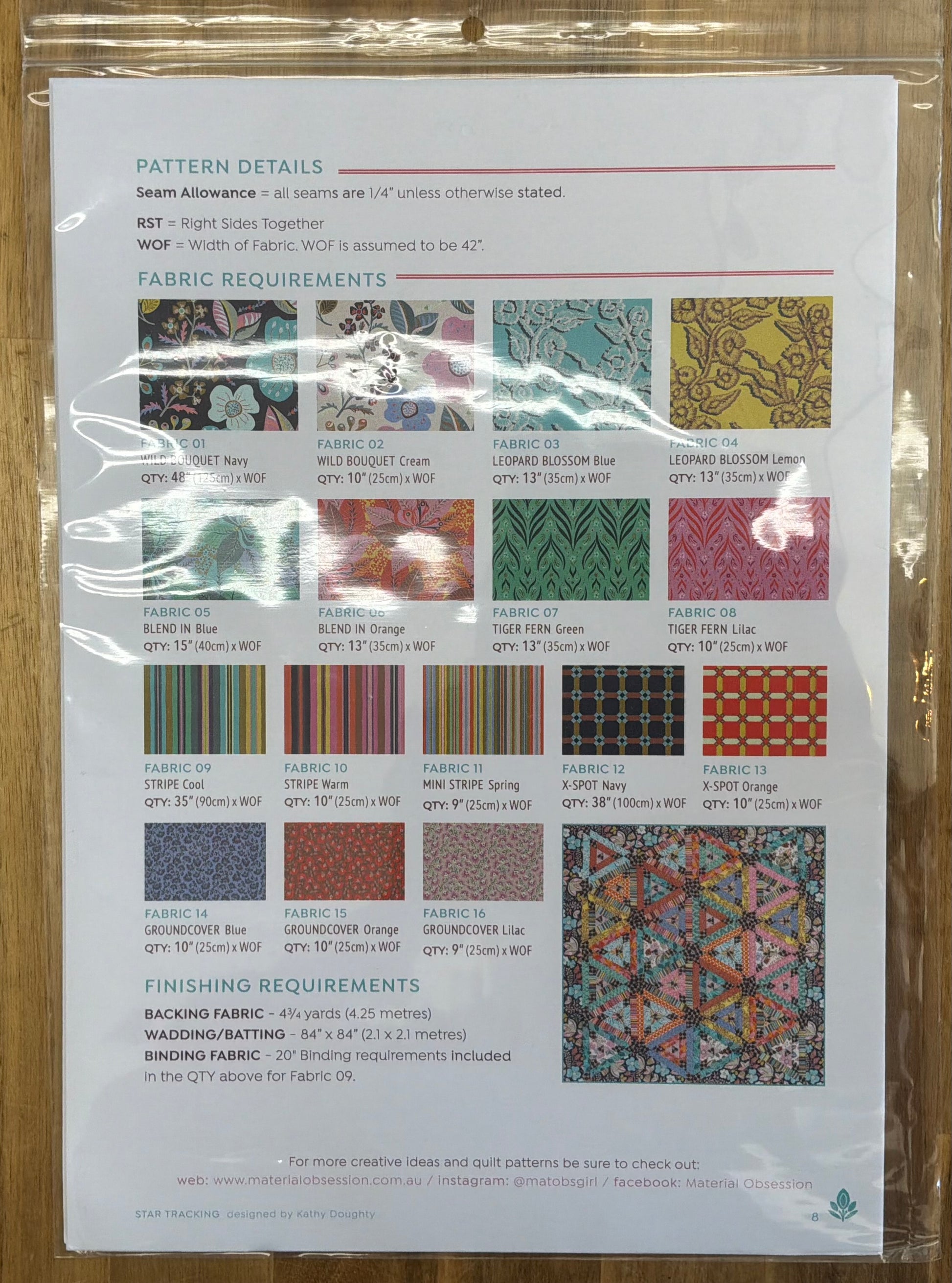 Pattern details sheet with fabric swatches and measurements on a wooden surface