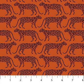 Pattern of leopards on an orange background with a fabric yardstick at the bottom.