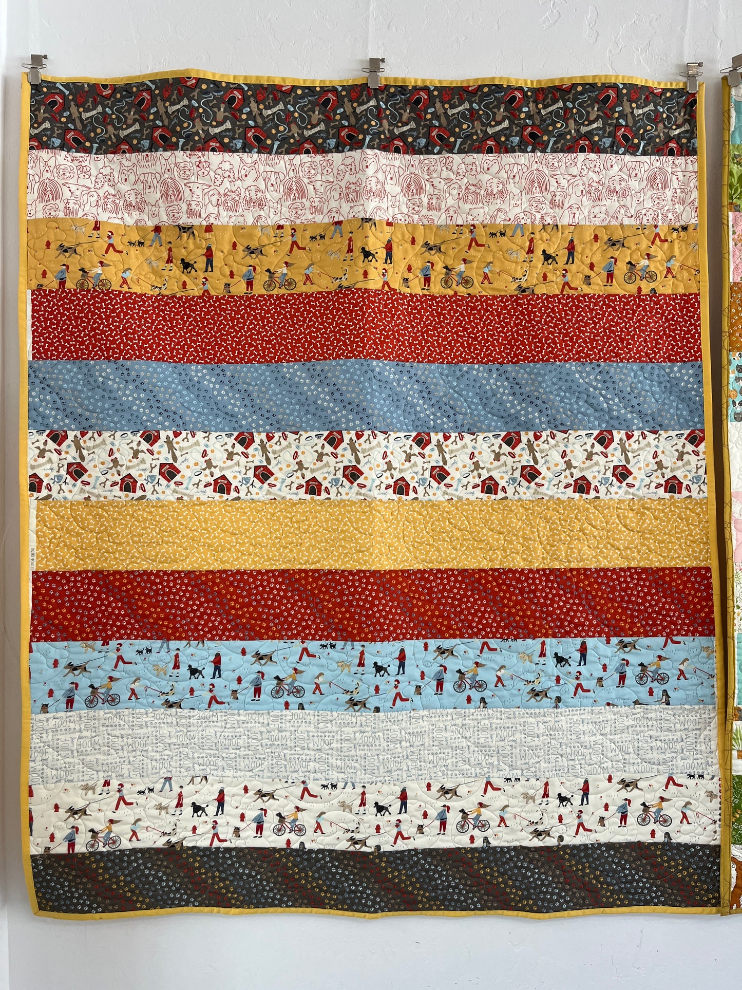 Striped quilt with various patterns and colors on a white background