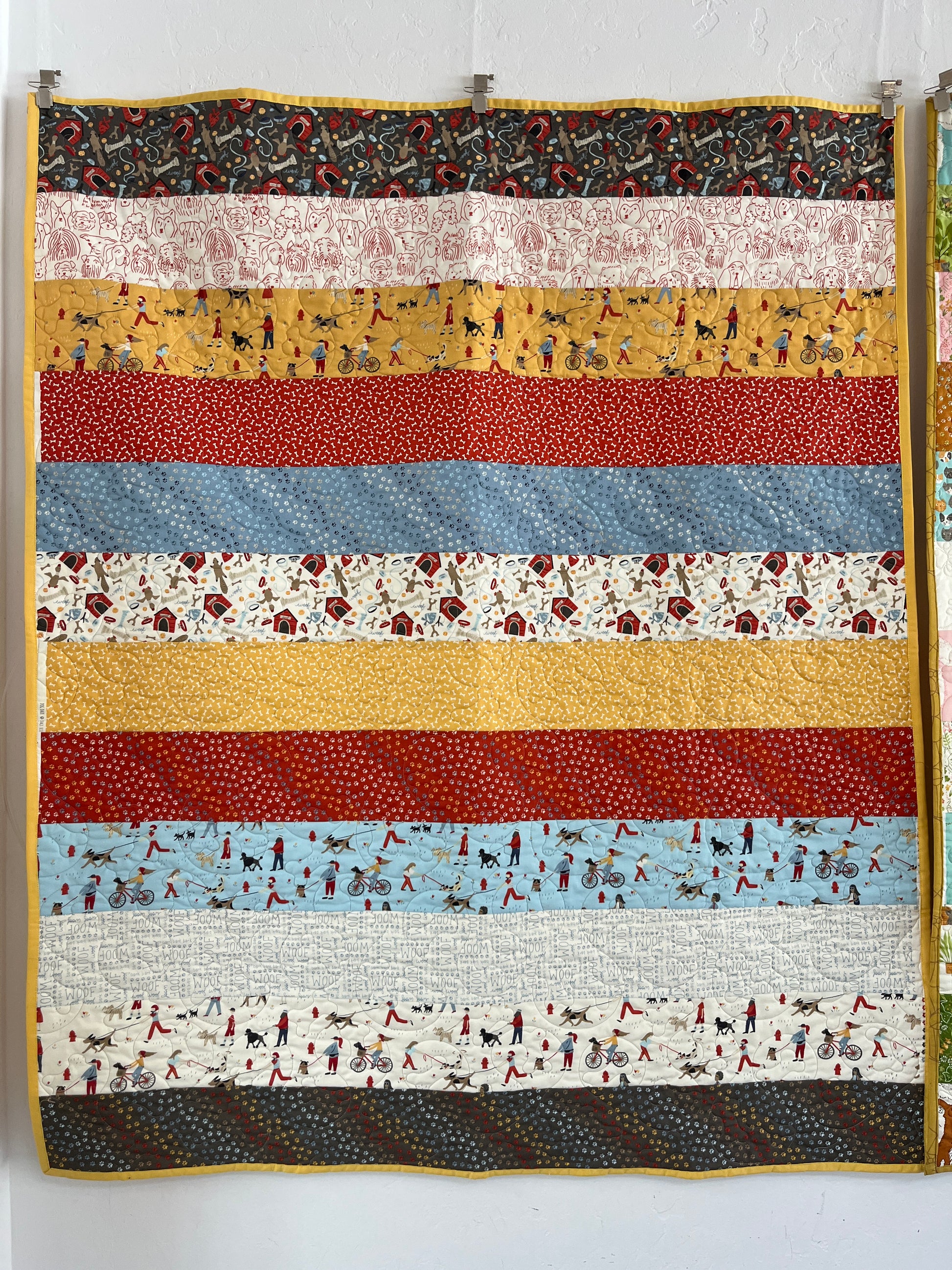Striped quilt with various patterns and colors on a white background
