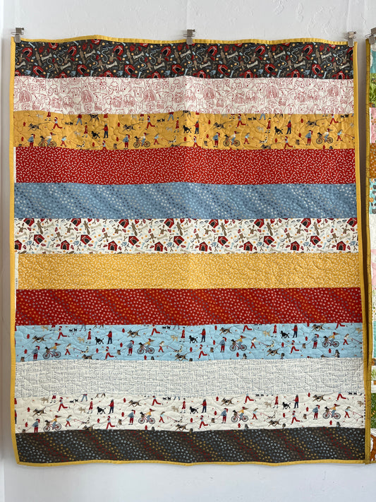 Striped quilt with various patterns and colors on a white background