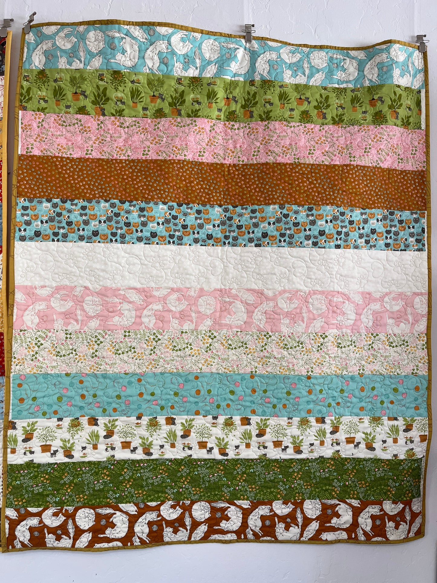 Striped quilt with various patterns and colors on a white background