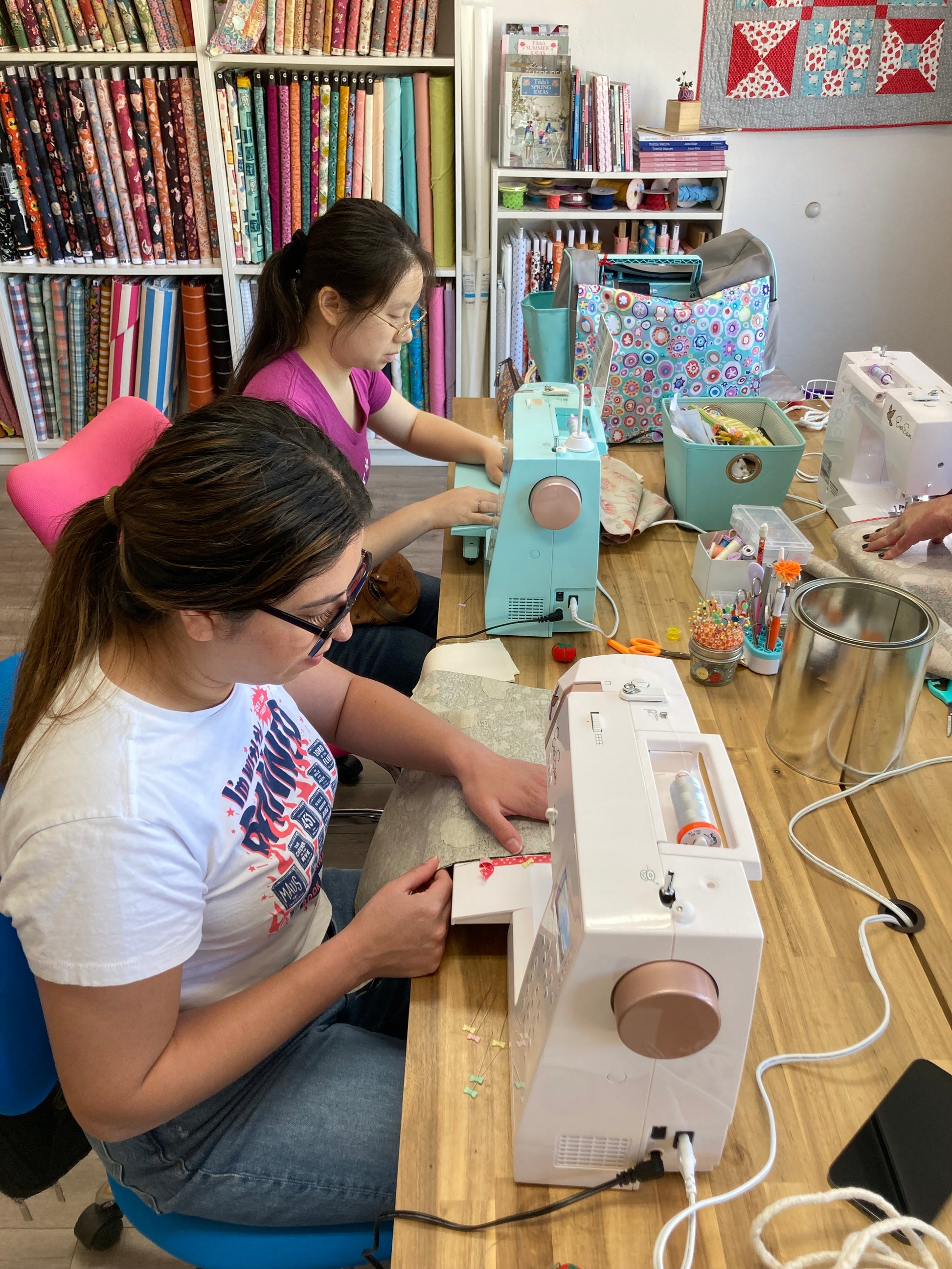 2 people sewing at a table