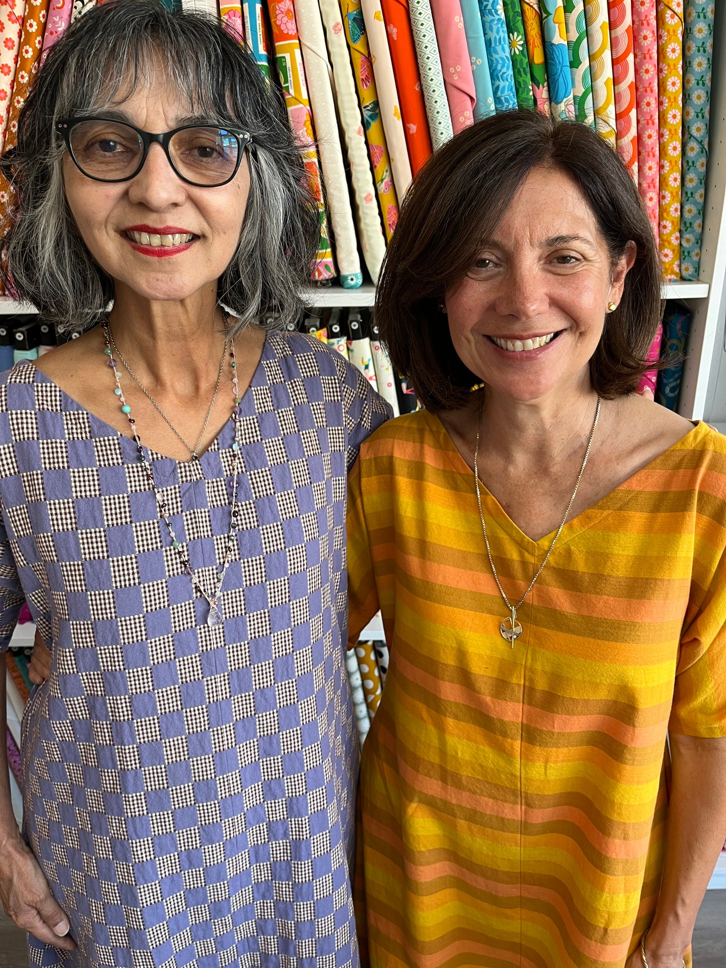 close up of Lana and Angela in colorful patterned dresses