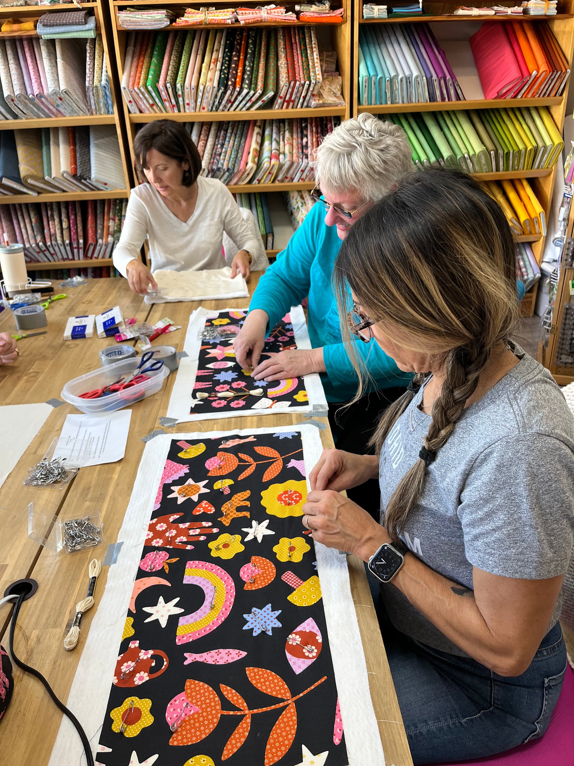 three women in the process of making the bags