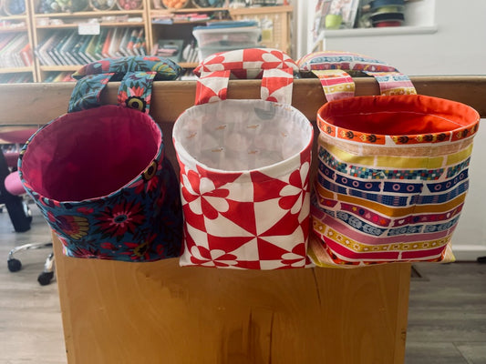 colorful fabric bins hanging from a table