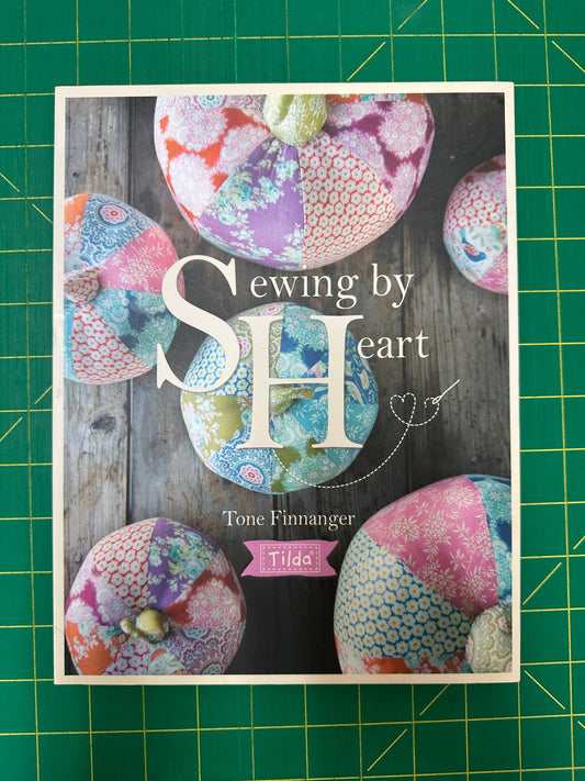 Book titled Sewing by Heart on a green cutting mat 