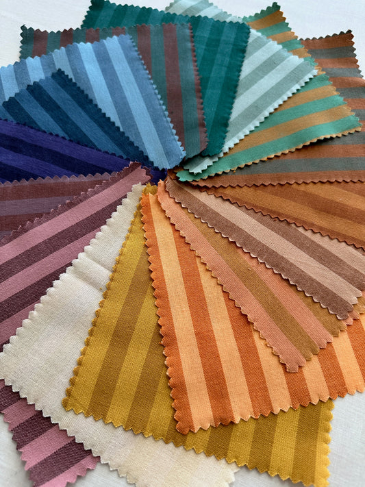 Fableism Sun Stripe Fabric close up, featuring colorful striped fabric cut into squares 