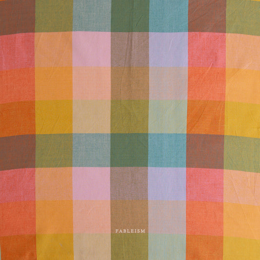 Multicolored checkered fabric with 'Fableism' branding