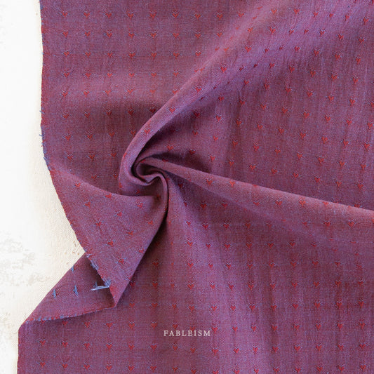 Textured dark burgundy fabric with small red hearts