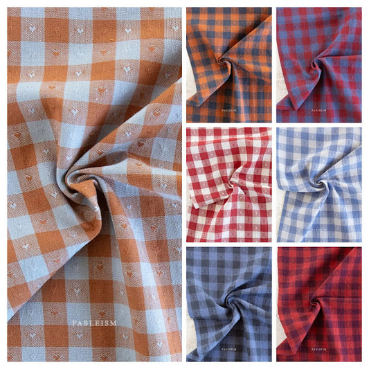 collage of gingham woven prints with heart accent dots, reds, blues