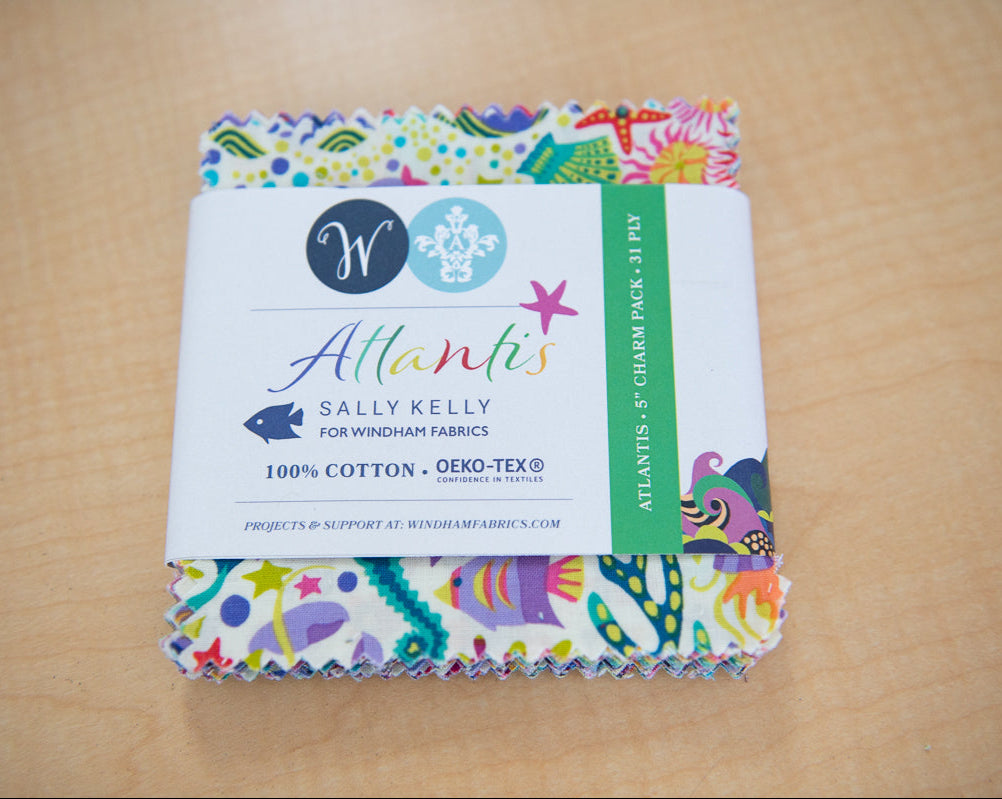 Pack of fabric with colorful sea-themed design on a wooden surface