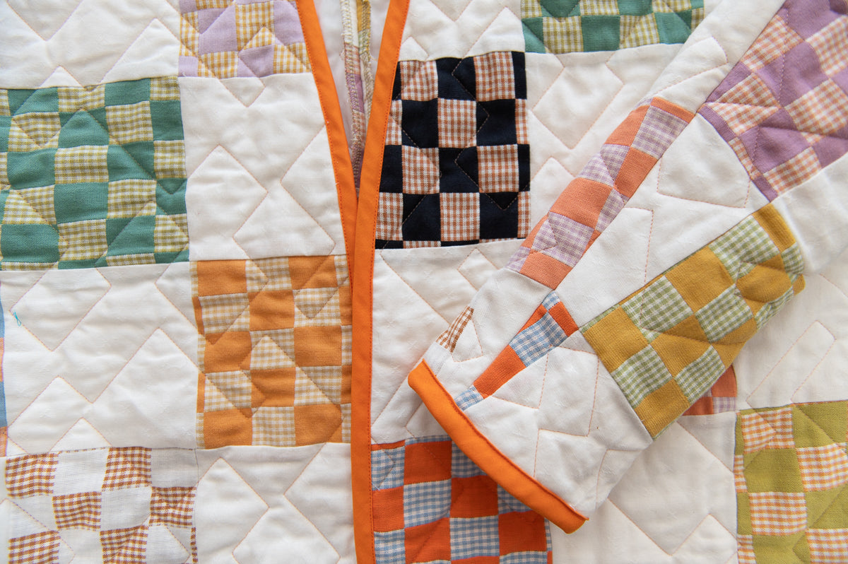 Quilted coat with various patchwork patterns in a close-up view