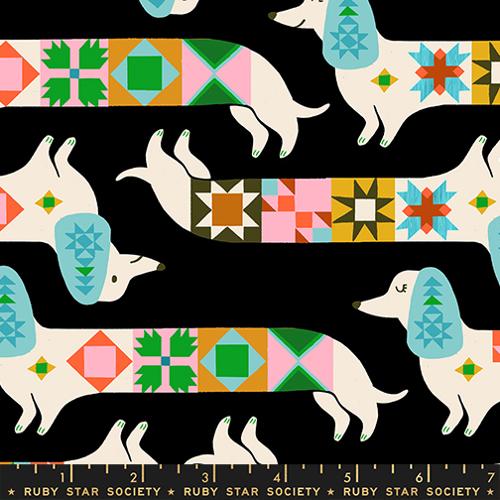 Patterned fabric with dogs and colorful geometric shapes on a black background, featuring Ruby Star Society branding.
