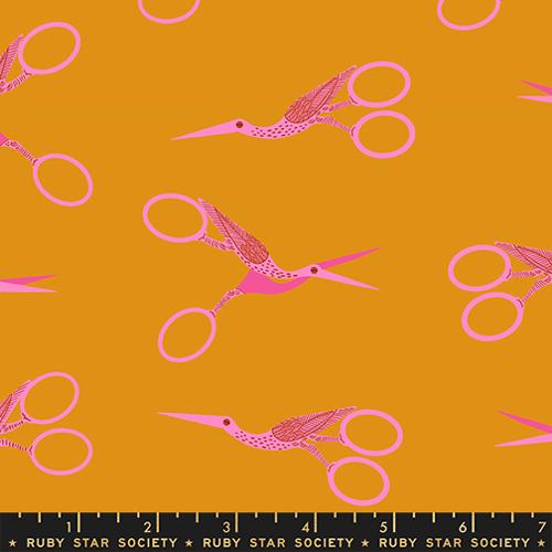 Pattern of pink scissors shaped like Storks on a mustard yellow background with Ruby Star Society label.