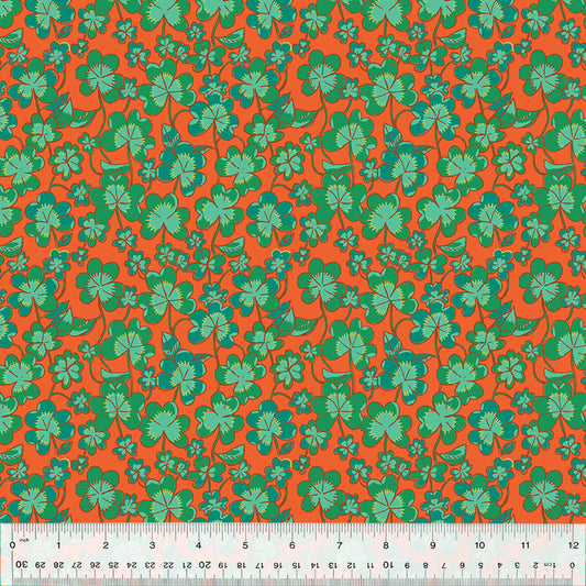 green clovers on orange fabric 

