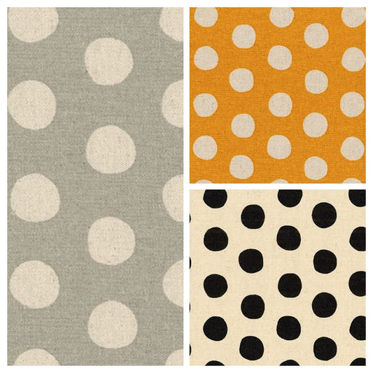 Three fabric swatches with polka dot patterns in different colors.
