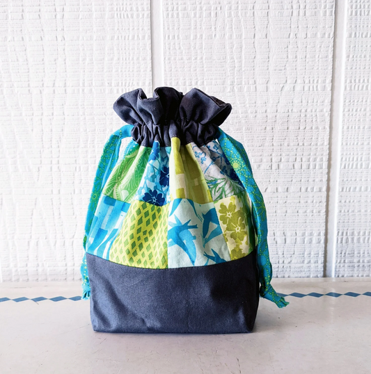 Drawstring bag with blue and green pattern on a white background