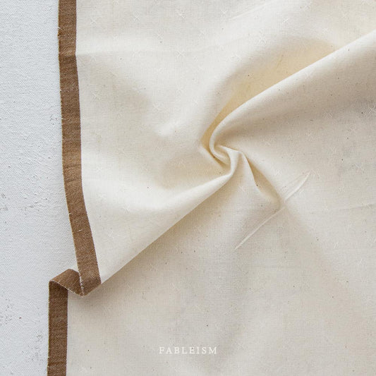 white fabric with a brown border