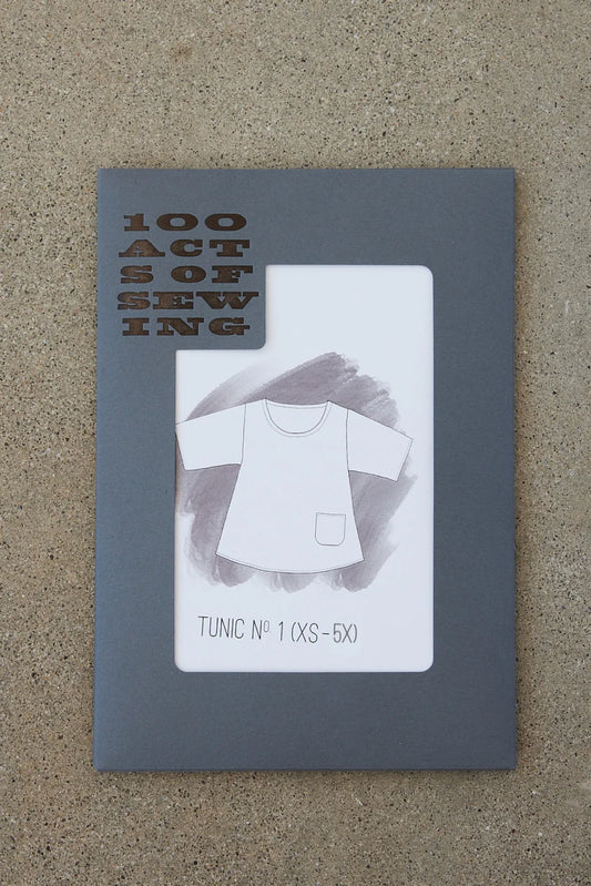 Physical packaging of a paper sewing pattern featuring a line drawing of a tunic