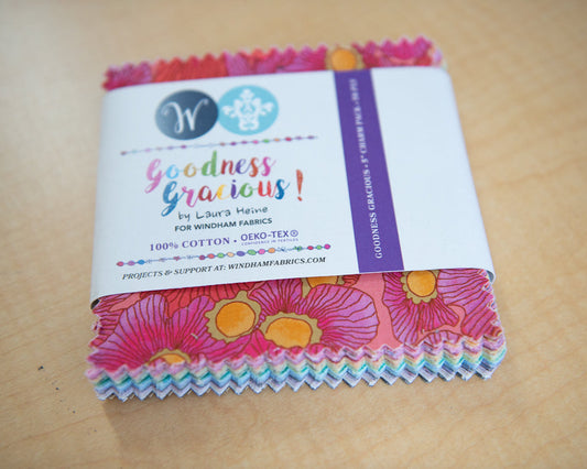 Pack of colorful fabric squares with a label on a wooden surface