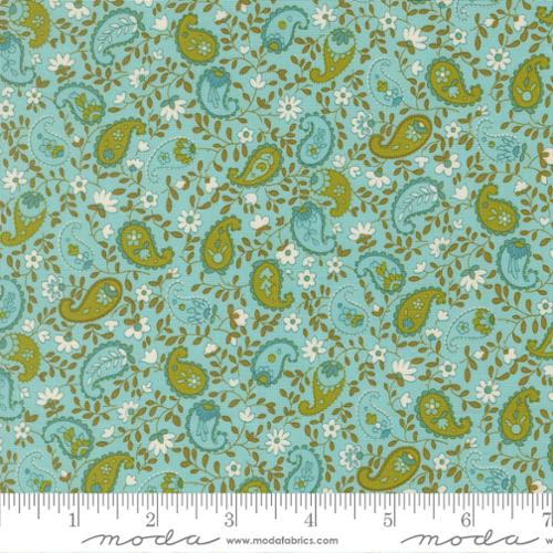 Blue and green paisley print with white flowers and green leafy vines winding between on a blue background