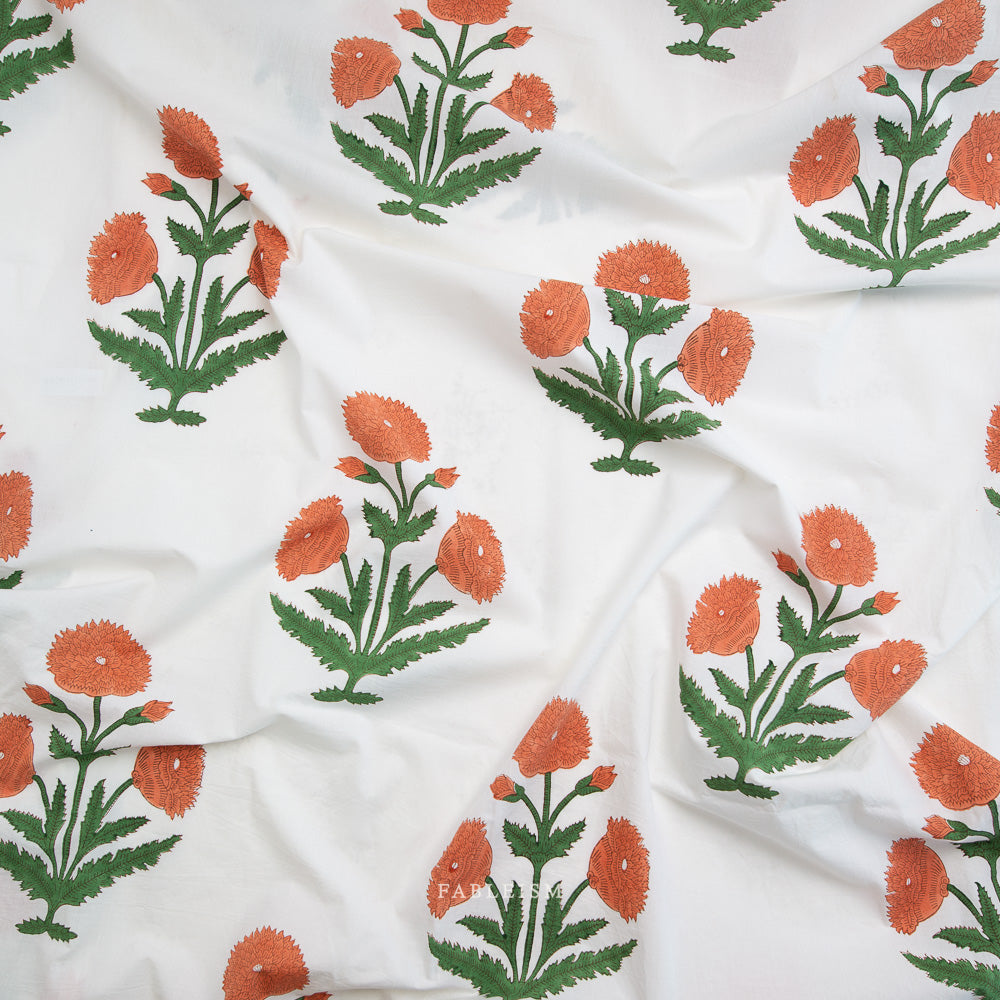 White fabric with orange and green floral patterns